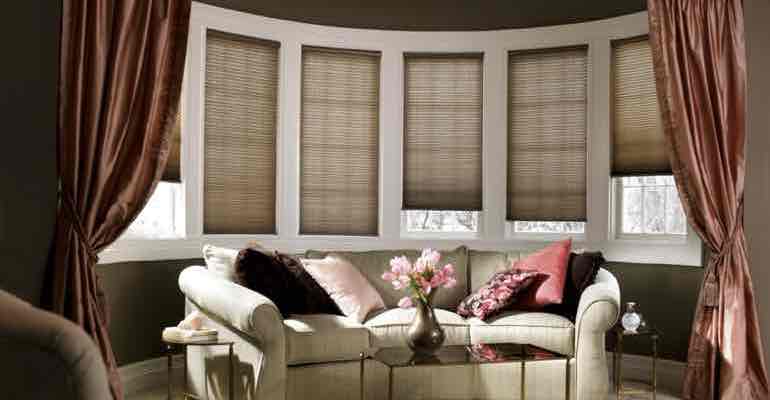 Brown honeycomb shades in parlour bow window.